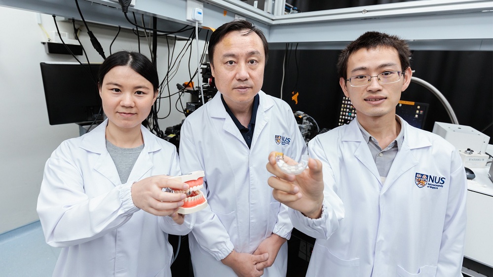 An NUS research team led by Prof Liu Xiaogang (centre) has created a revolutionary mouthguard that uses bite force to operate electronic devices such as computers, smartphones and even wheelchairs with high accuracy.